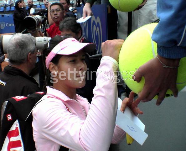 Ana Ivanovic of Serbia and Montenegro signs a tennis ball for a fan during day two of the Italian Masters Tennis at The Foro Italico on May 10, 2005 in Rome