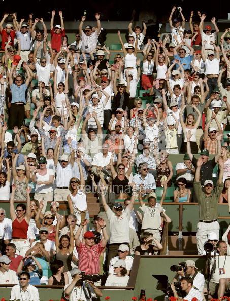 Spectators make the "Ola" during the third round match of the tennis French Open at Roland Garros between Amelie Mauresmo of France and Ana Ivanovic of Serbia, 28 May 2005 in Paris