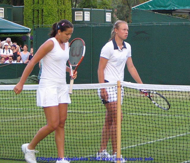 Ana Ivanovic  and Vera Douchevina of Russia leave the court after the first round match