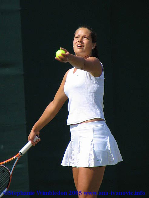 Ana Ivanovic  on the service during  the first round match in doubles against Flavia Pennetta and Francesca Schiavone   from Italy on June 22, 2005 at the All England Lawn Tennis and Croquet Club in London. Ana  and  Tina Krizan won 6:2 6:4 .