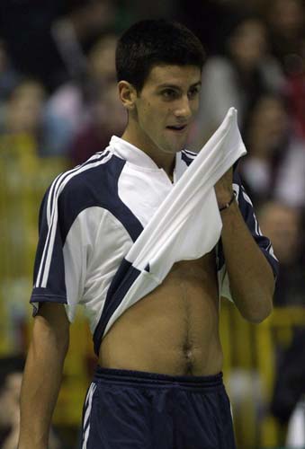 Novak Djokovic, the number 75 seed, returns the ball to Ana Ivanovic during their charity tennis match in Belgrade November 13, 2005. Two of Serbia's top tennis players take part in the match, with proceeds going to the reconstruction of the Belgrade TV tower Avala destroyed during the NATO air strikes in 1999