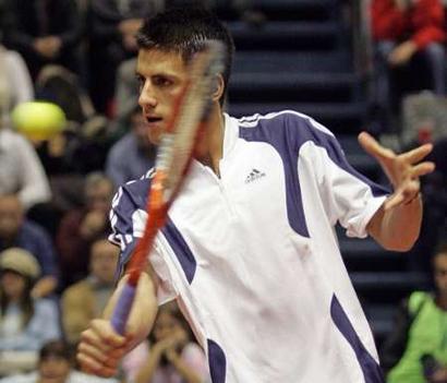 Novak Djokovic, the number 75 seed, returns the ball to Ana Ivanovic during their charity tennis match in Belgrade November 13, 2005. Two of Serbia's top tennis players take part in the match, with proceeds going to the reconstruction of the Belgrade TV tower Avala destroyed during the NATO air strikes in 1999