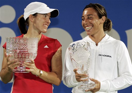 Justine Henin-Hardenne of Belgium, left, and Francesca Schiavone of Italy enjoy a light moment during the trophy ceremony after their final match at the Sydney International tennis tournament in Sydney, Australia, Friday, Jan. 13, 2006. Henin-Hardenne won the match 4-6, 7-5, 7-5. 