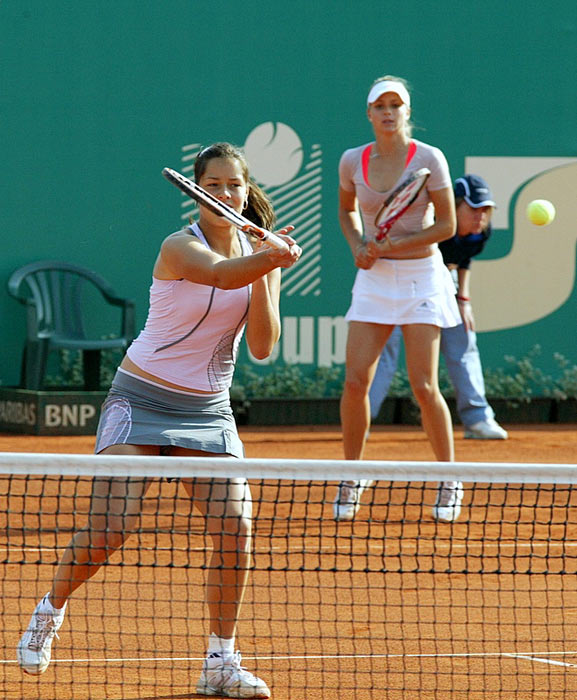 Russia's Maria Kirilenko and Ana Ivanovic beat the top-seeded pair of South Africa's Liezel Huber and the United States' Martina Navratilova 6-2, 6-4