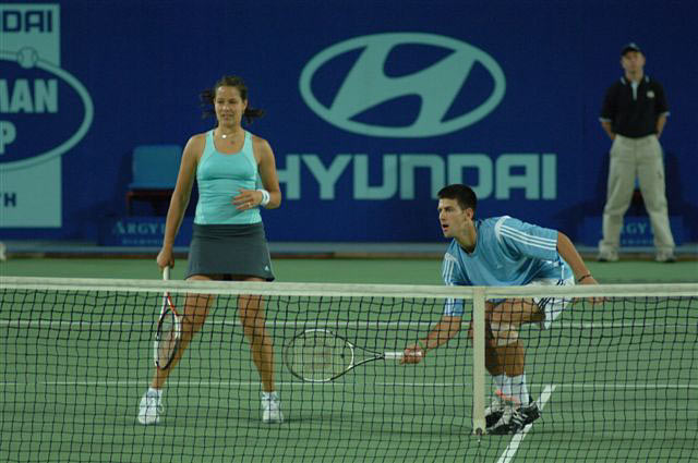 Ana Ivanovic (L) of Serbia and Montenegro and Novak Djokovic during their mixed doubles match against Sofia Arvidsson and Thomas Johansson of Sweden during the Hopman Cup in Perth, Australia January 2, 2006. Serbia and Montenegro won the match 6-2 6-4.