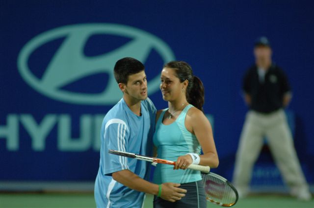 Ana Ivanovic (L) of Serbia and Montenegro and Novak Djokovic during their mixed doubles match against Sofia Arvidsson and Thomas Johansson of Sweden during the Hopman Cup in Perth, Australia January 2, 2006. Serbia and Montenegro the match 6-2 6-4.