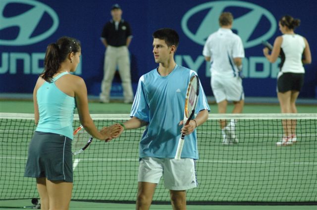 Ana Ivanovic (L) of Serbia and Montenegro and Novak Djokovic during their mixed doubles match against Sofia Arvidsson and Thomas Johansson of Sweden during the Hopman Cup in Perth, Australia January 2, 2006. Serbia and Montenegro the match 6-2 6-4.