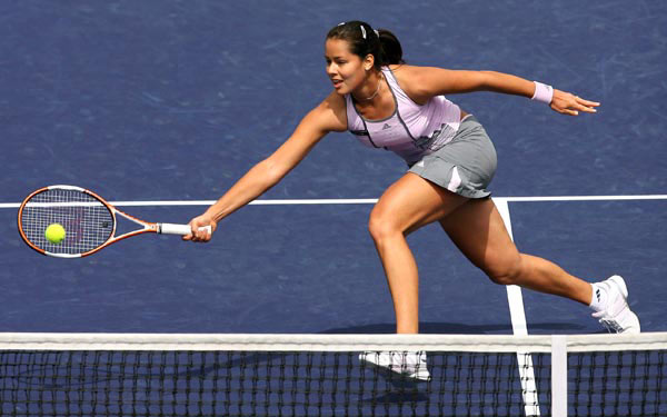 Ana Ivanovic of Serbia and Montenegro returns the ball to Amelie Mauresmo of France at the Nasdaq- 100 Open tennis tournament in Key Biscayne, Fla. Monday, March 27, 2006