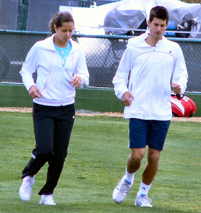 Novak Djokovic and Ana Ivanovic jog and stretch before practicing