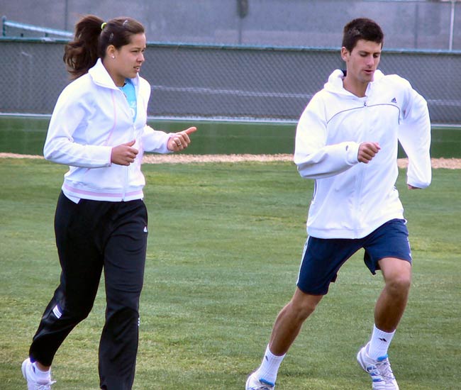 Novak Djokovic and Ana Ivanovic jog and stretch before practicing