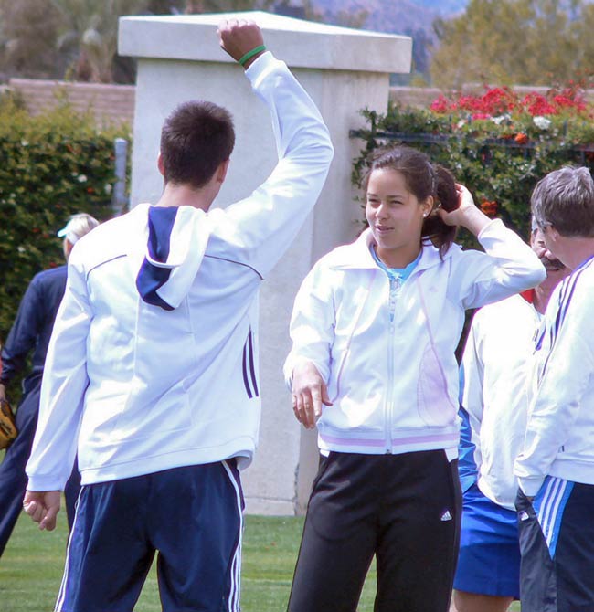 Novak Djokovic and Ana Ivanovic jog and stretch before practicing