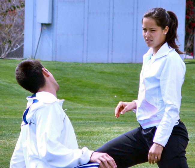 Novak Djokovic and Ana Ivanovic jog and stretch before practicing