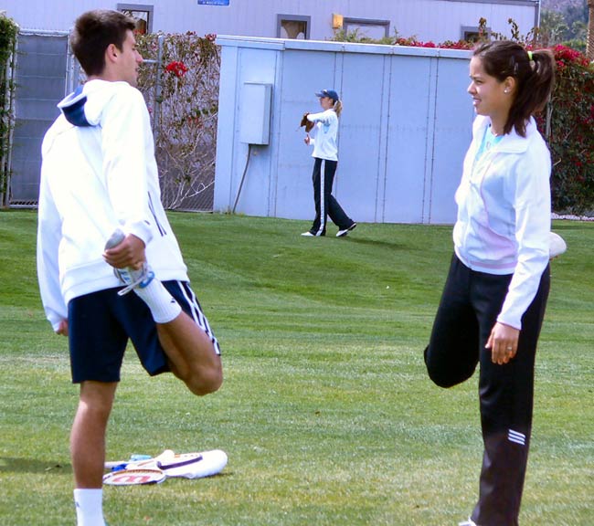 Novak Djokovic and Ana Ivanovic jog and stretch before practicing