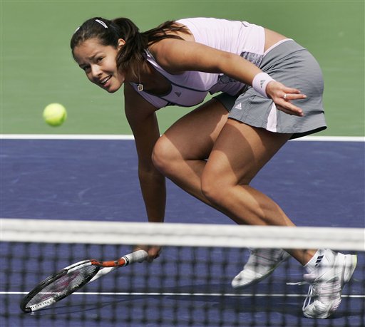 Ana Ivanovic  bends low for a volley to Elena Dementieva during quarterfinal action at the Pacific Life Tennis Open in Indian Wells, Calif. Thursday, March 16, 2006.