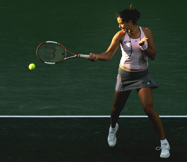 Ana Ivanovic of Serbia and Montenegro returns the ball to Amelie Mauresmo of France at the Nasdaq- 100 Open tennis tournament in Key Biscayne, Fla. Monday, March 27, 2006