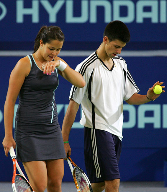 Ana Ivanovic (L) and Novak Djokovic of Serbia and Montenegro during their mixed doubles match against Lisa Raymond and Taylor Dent from the U.S. at the Hopman Cup in Perth, Australia January 1, 2006.