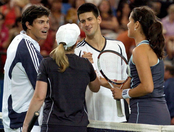 Ana Ivanovic (L) and Novak Djokovic of Serbia and Montenegro during their mixed doubles match against Lisa Raymond and Taylor Dent from the U.S. at the Hopman Cup in Perth, Australia January 1, 2006. The U.S. team won the match 7-6 6-2.