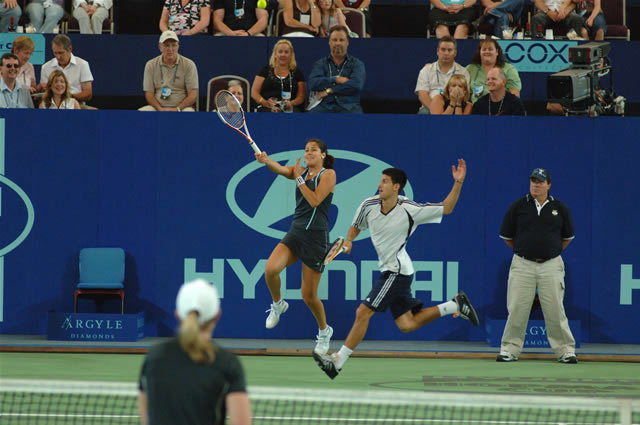 Ana Ivanovic (L) and Novak Djokovic of Serbia and Montenegro during their mixed doubles match against Lisa Raymond and Taylor Dent from the U.S. at the Hopman Cup in Perth, Australia January 1, 2006.