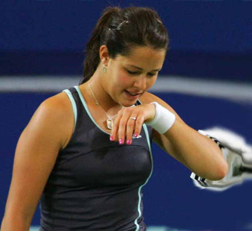 Ana Ivanovic (L) during their mixed doubles match against Lisa Raymond and Taylor Dent from the U.S. at the Hopman Cup in Perth, Australia January 1, 2006.