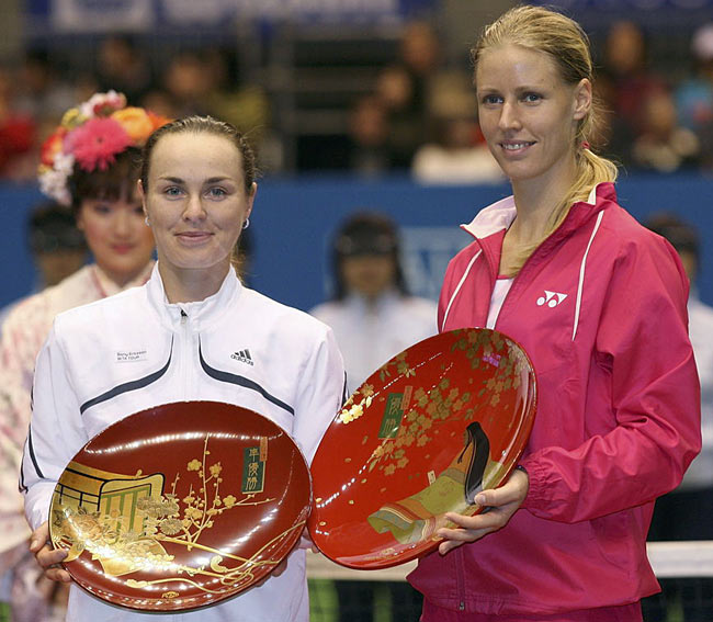 Elena Dementieva of Russia, right, and Martina Hingis of Switzerland, left, pose with the plates at the awarding ceremony of the Pan Pacific Open tennis tournament in Tokyo Sunday, Feb. 5, 2006. Dementieva defeated Hingis in the final, 6-2, 6-0. 